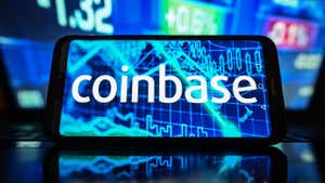 Coinbase logo displayed on a smartphone.